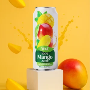 A can of Vinut 100% Mango Juice is displayed on a white block, surrounded by fresh mango slices, a whole mango, and splashes of juice against a yellow background.
