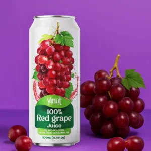 A can of Vinut 100% Red Grape Juice stands beside a bunch of fresh red grapes on a purple surface with a purple background.