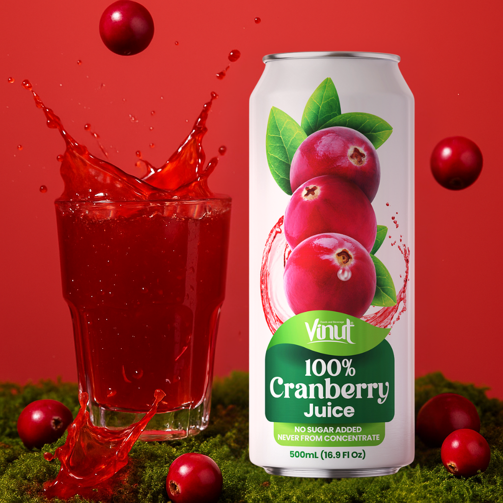A can of Vinut 100% Cranberry Juice next to a glass of splashing red juice, with whole cranberries and green moss on a red background.