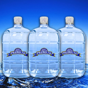 Three large clear water jugs, each labeled "Crystal Premium Purified," are displayed in a row against a blue background with water at the bottom, showcasing the 3 Gallon Glass Bottle Plan.