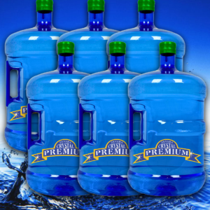 Six large blue water jugs with green caps, labeled "Crystal Premium," are arranged in two rows against a blue water splash background, perfect for any bottle plan or spring water needs.