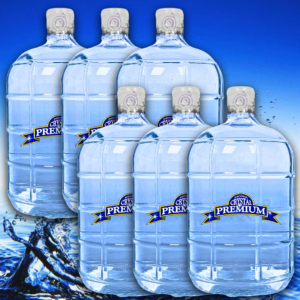 Six large Crystal Premium water jugs are arranged in two rows against a blue background with splashing water at the bottom, highlighting the purity of this purified water—ideal for any bottle plan or those seeking a reliable 3 gallon glass alternative.